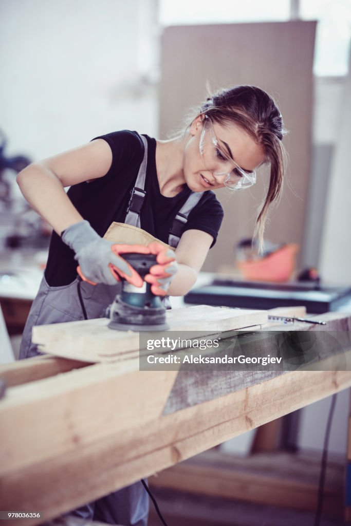 Cute Female Carpenter Preparing Wood For Manufacturing