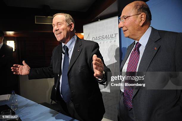 Charles Edelstenne, chairman and chief executive officer of Dassault Aviation SA, left, gestures during a news conference, as Serge Dassault,...