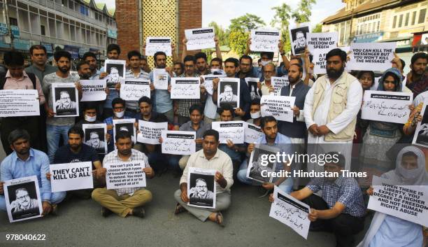 Journalists of Rising Kashmir joined by other journalists from various media hold placards during sit-in protest against the killing of Shujaat...