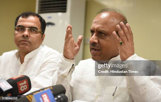 Opposition leader Vijender Gupta speaks as Parvesh Verma looks on during a press conference on the sixth day of their sit-in protest at Delhi CM...