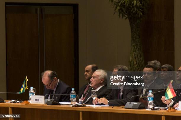 Michel Temer, Brazil's president, center, listens during a meeting at the Mercosur Summit in Asuncion, Paraguay, on Monday, June 18, 2018. The...