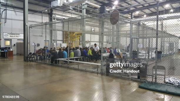 In this handout photo provided by U.S. Customs and Border Protection, U.S. Border Patrol agents conduct intake of illegal border crossers at the...