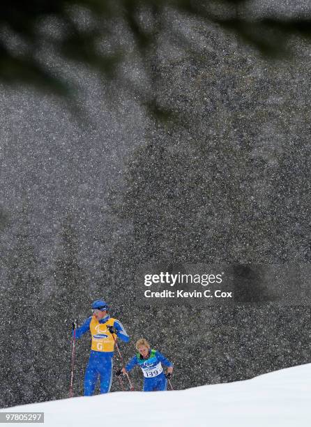 Mikhalina Lysova of Russia follows her guide Alexey Ivanov while competing in the Women's 12.5 KM Visually Impaired Biathalon event during Day 6 of...