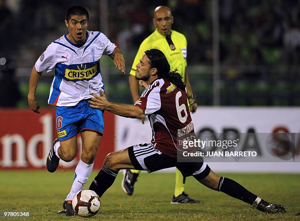 Venezuelan Caracas FC player Jaime Bustamante vies for the ball with Chilean Francisco Silva of Universidad Catolica during their Copa Libertadores...