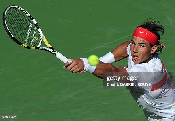 Rafael Nadal of Spain returns a shot to John Isner of the US during the BNP Paribas Open on March 17, 2010 at the Indian Wells Tennis Garden in...