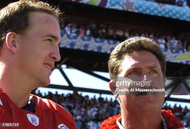 Indianapolis Colts quarterback Peyton Manning talks with Miami Dolphins quarterback Dan Marino before the 2005 Pro Bowl game at Aloha Stadium,...