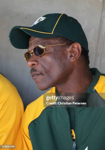 Special instructor Rickey Henderson of the Oakland Athletics sits in the dugout during the MLB spring training game against the San Francisco Giants...