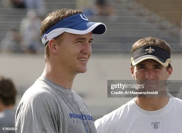 Indianapolis Colts quarterback Peyton Manning talks with New Orleans Saints quarterback Drew Brees at Veterans Memorial Stadium in Jackson,...