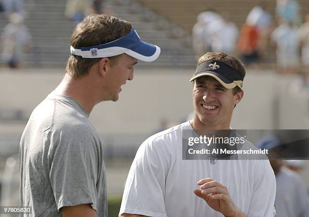 Indianapolis Colts quarterback Peyton Manning talks with New Orleans Saints quarterback Drew Brees at Veterans Memorial Stadium in Jackson,...