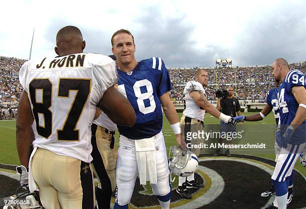 Indianapolis Colts quarterback Peyton Manning greets New Orleans Saints wide receiver Joe Horn before the coin toss at Veterans Memorial Stadium in...