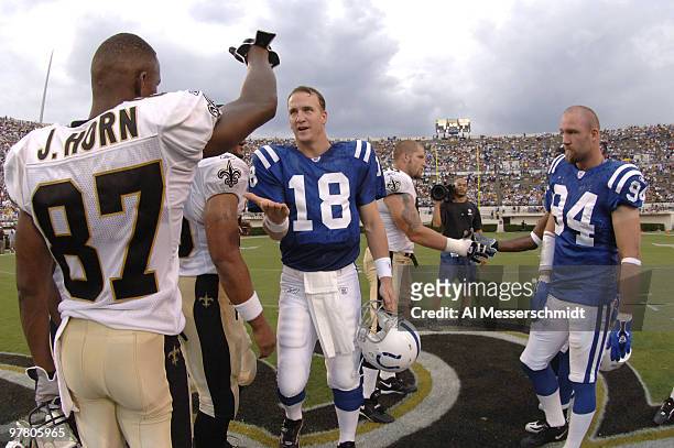 Indianapolis Colts quarterback Peyton Manning greets New Orleans Saints wide receiver Joe Horn before the coin toss at Veterans Memorial Stadium in...