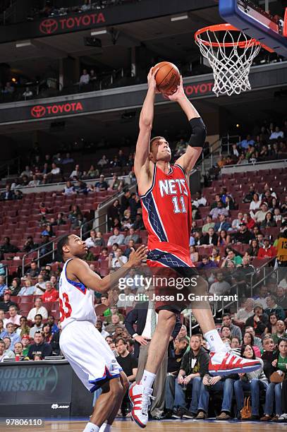 Brook Lopez of the New Jersey Nets shoots against Willie Green of the Philadelphia 76ers during the game on March 17, 2010 at the Wachovia Center in...