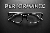 Text performance with eyeglasses on black background / business concept / dark tone
