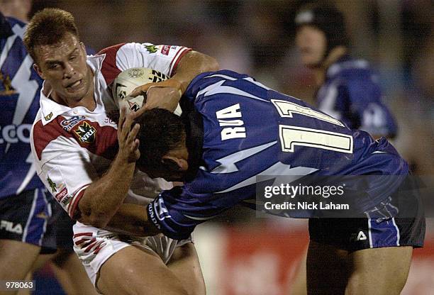 Wayne Bartrim of the St George Illawarra is tackled by Matt Rua of the Melbourne Storm during the Round 3 NRL match between the St George Illawarra...