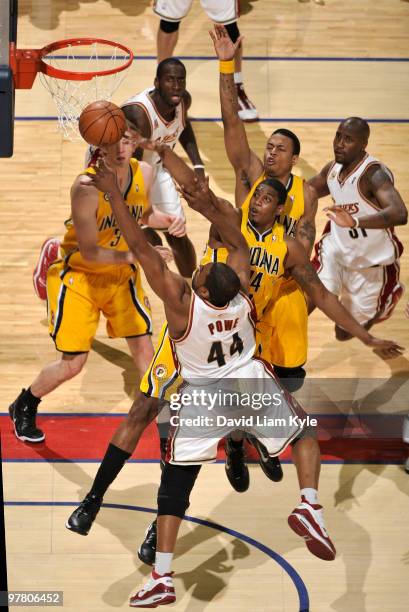 Leon Powe of the Cleveland Cavaliers has his shot blocked by Solomon Jones of the Indiana Pacers on March 17, 2010 at The Quicken Loans Arena in...