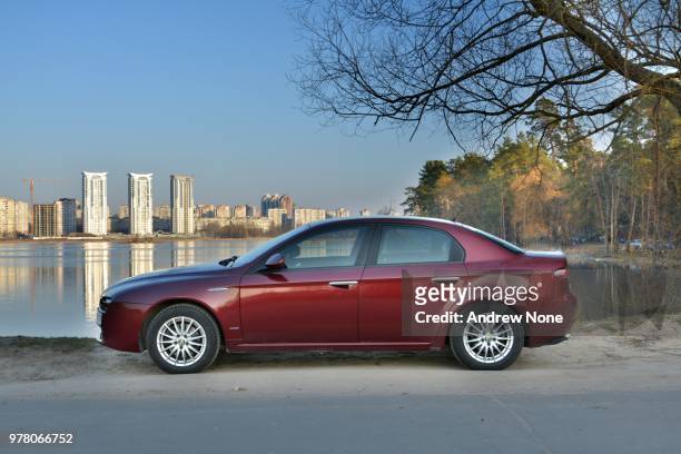 alfa romeo 159 at the lake - saloon car stock pictures, royalty-free photos & images
