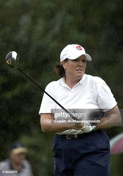 Meg Mallon follows her drive in the rain on the fourth hole Thursday, October 9, 2003 at the Samsung World Championship in Houston, Texas. Rain...