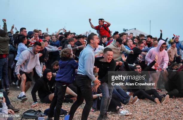 The crowd watching the match at Lunar cinema on Brighton beach react to Englands Harry Kane as he scores the winner as England play Tunisia in the...