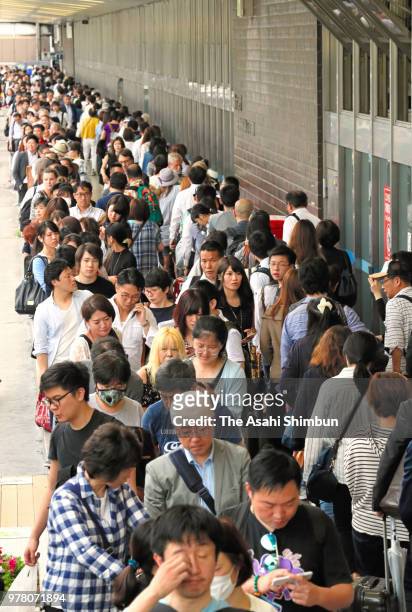 People wait for taxi after the magnitude 6.1 strong earthquake affect the train services at Shin Osaka station on June 18, 2018 in Osaka, Japan. A...