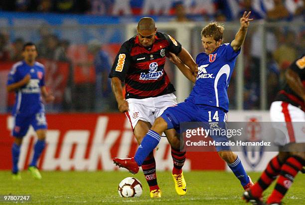 Adriano of Brazil's Flamengo vies for the ball with Felipe Seymour of Chile's Universidad de Chile during a match as part of the Santander...