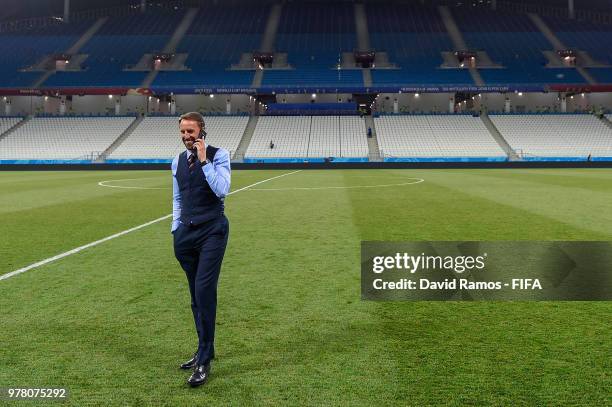 Gareth Southgate Manager of England speaks on his phone on the pitch at the end of the 2018 FIFA World Cup Russia group G match between Tunisia and...