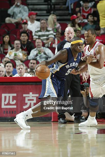 Zach Randolph of the Memphis Grizzlies drives the ball past Chuck Hayes of the Houston Rockets on March 17, 2010 at the Toyota Center in Houston,...