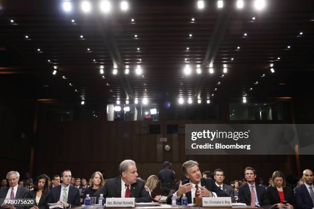 Christopher Wray, director of the Federal Bureau of Investigation , center right, speaks while Michael Horowitz, inspector general with the U.S....