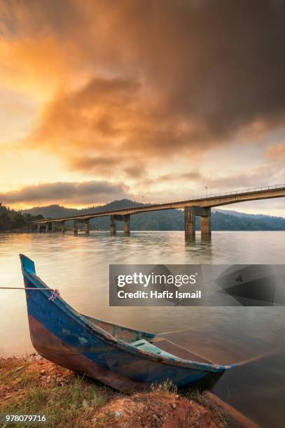 view of belum rainforest with boat and bridge over river, perak, malaysia - perak state stock pictures, royalty-free photos & images