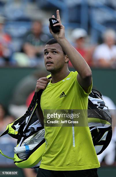 Jo-Wilfried Tsonga of France acknowledges the fans as he walks off the court after losing to Robin Soderling of Sweden during the BNP Paribas Open at...