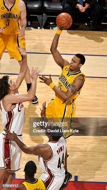 Brandon Rush of the Indiana Pacers shoots over Anderson Varejao of the Cleveland Cavaliers on March 17, 2010 at The Quicken Loans Arena in Cleveland,...