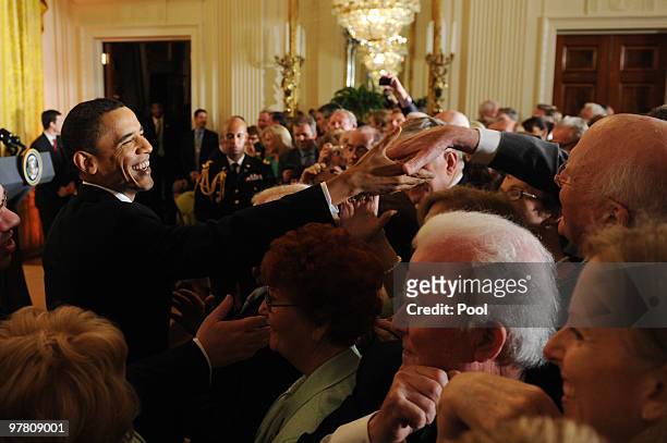 President Barack Obama shakes hands with senator Patrick Leahy following the annual St. Patrick's Day Reception in the East Room of the White House,...