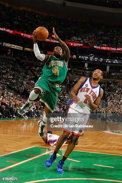 Nate Robinson of the Boston Celtics drives the lane against Chris Duhon of the New York Knicks on March 17, 2010 at the TD Garden in Boston,...