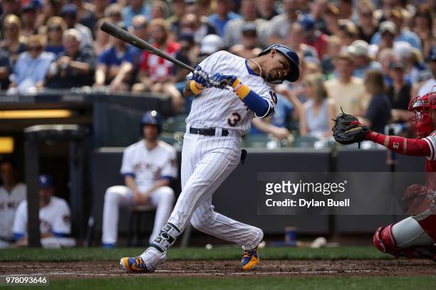 Orlando Arcia of the Milwaukee Brewers ducks to avoid being hit by a pitch in the third inning against the Philadelphia Phillies at Miller Park on...
