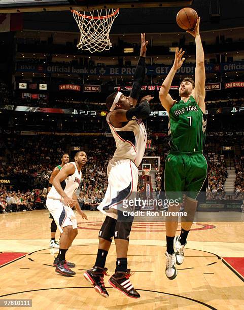 Andrea Bargnani of the Toronto Raptors takes the hookshot in the paint over Josh Smith of the Atlanta Hawks during a game on March 17, 2010 at the...