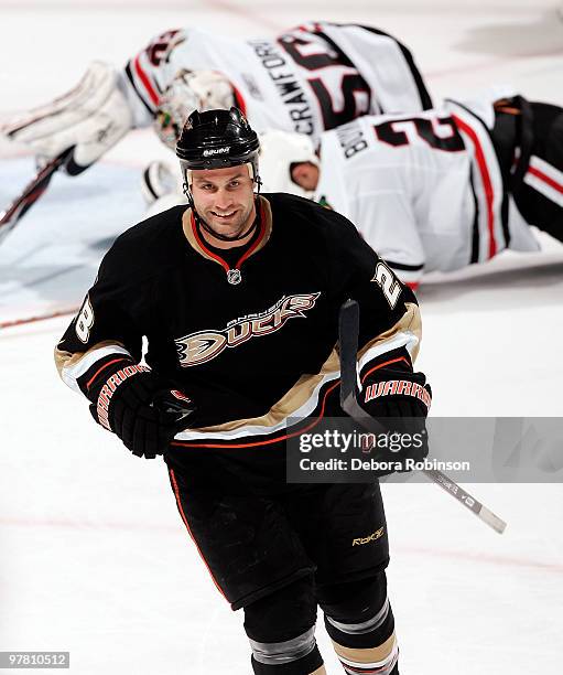 Kyle Chipchura of the Anaheim Ducks celebrates his assist to teammate Todd Marchant as Corey Crawford and Nick Boynton of the Chicago Blackhawks fall...