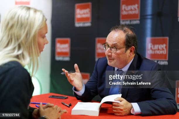 Former French President Francois Hollande signs his book 'Les lecons du pouvoir' at Furet du Nord bookshop on June 18, 2018 in Lille, France.