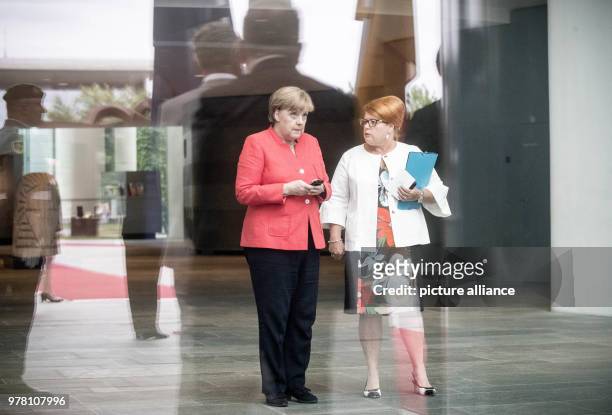 June 2018, Germany, Berlin: German Chancellor Angela Merkel standing next to Federal Chancellery employee Simone Lehmann-Zwiener ahead of meeting...