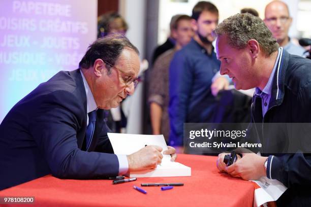 Former French President Francois Hollande signs his book 'Les lecons du pouvoir' at Furet du Nord bookshop on June 18, 2018 in Lille, France.