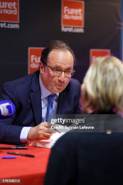 Former French President Francois Hollande signs his book 'Les lecons du pouvoir' at Furet du Nord bookshop on June 18, 2018 in Lille, France.