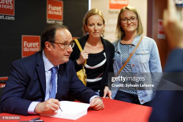 Former French President Francois Hollande signs his book 'Les lecons du pouvoir' at Furet du Nord bookshop on June 18, 2018 in Lille, France.