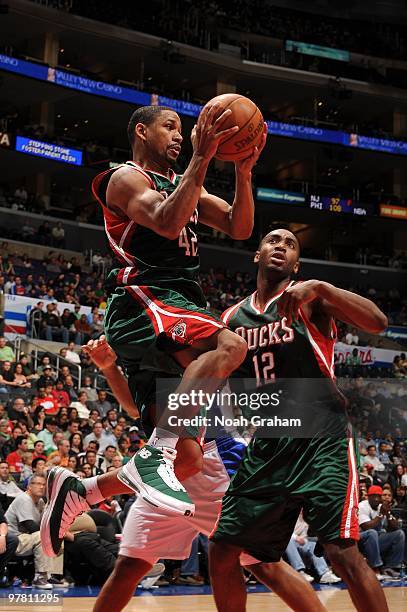 Charlie Bell of the Milwaukee Bucks leaves his feet looking to make a pass while teammate Luc Mbah a Moute looks on during their game against the Los...