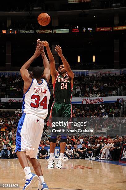 Jerry Stackhouse of the Milwaukee Bucks shoots over Travis Outlaw of the Los Angeles Clippers at Staples Center on March 17, 2010 in Los Angeles,...