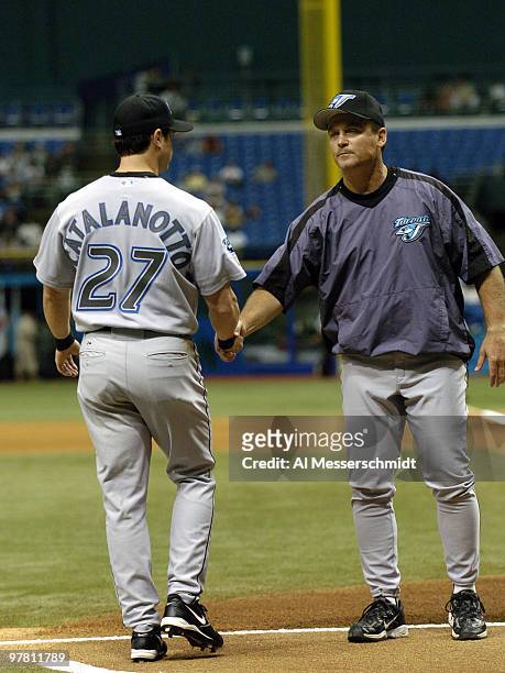 Toronto Blue Jays manager John Gibbons welcomes infielder Frank Catalanotto before the season opener April 4, 2005 against the Tampa Bay Devil Rays....