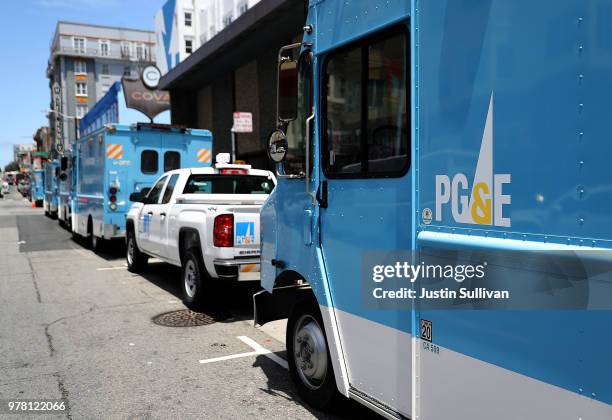 Pacific Gas and Electric trucks sit parked on a street on June 18, 2018 in San Francisco, California. California lawmakers are saying that PG&E is...