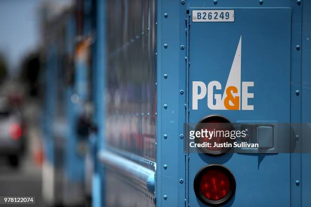 Pacific Gas and Electric trucks sit parked on a street on June 18, 2018 in San Francisco, California. California lawmakers are saying that PG&E is...
