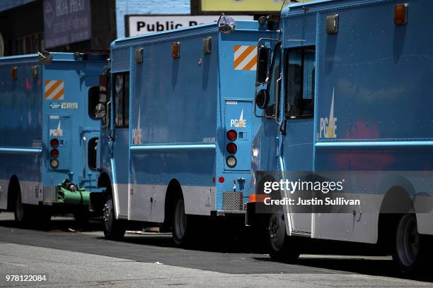 Pacific Gas and Electric trucks sit parked on a street on June 18, 2018 in San Francisco, California. California lawmakers are saying that PG&E is...