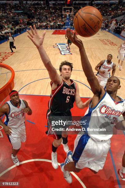 Travis Outlaw of the Los Angeles Clippers attempts a shot against Andrew Bogut of the Milwaukee Bucks at Staples Center on March 17, 2010 in Los...