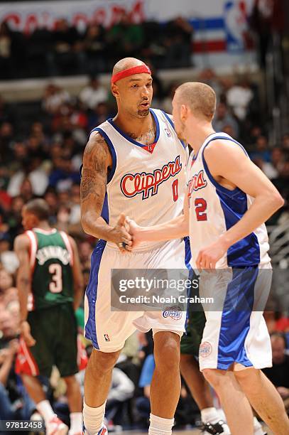 Drew Gooden and Steve Blake of the Los Angeles Clippers slap hands during a game against the Milwaukee Bucks at Staples Center on March 17, 2010 in...