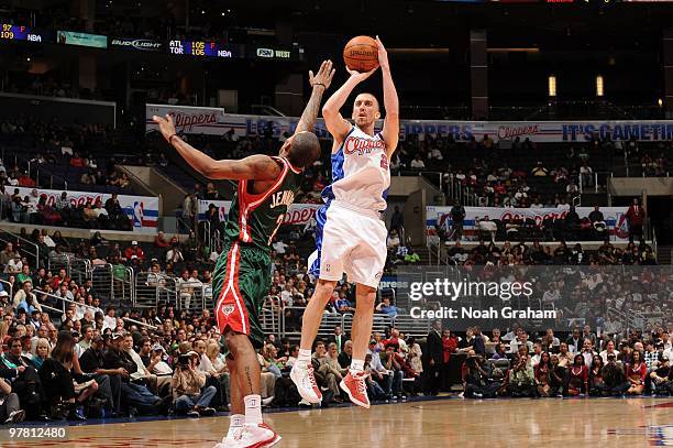 Steve Blake of the Los Angeles Clippers shoots against Brandon Jennings of the Milwaukee Bucks at Staples Center on March 17, 2010 in Los Angeles,...