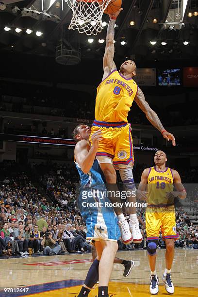Monta Ellis of the Golden State Warriors dunks against Darius Songalia of the New Orleans Hornets on March 17, 2010 at Oracle Arena in Oakland,...
